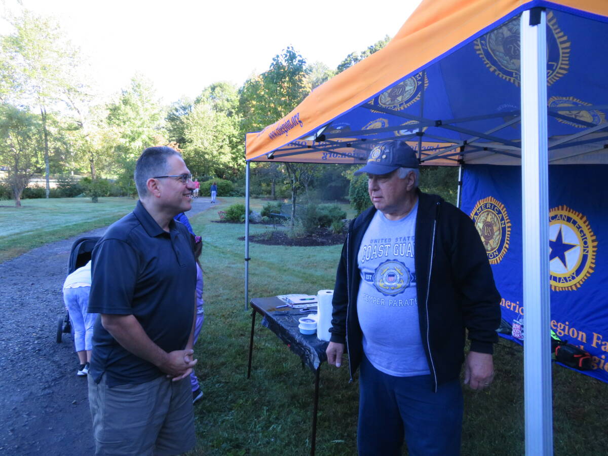 First Selectman Ken Kellogg talks to a veteran.