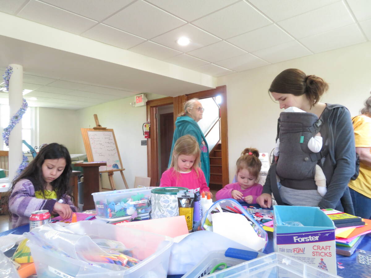 Brianna Andres, 7, left, does crafts with, from left, sisters Rose, 4, and Katherine Langer, 2, Irene Langer and her one-month-old son, John.
