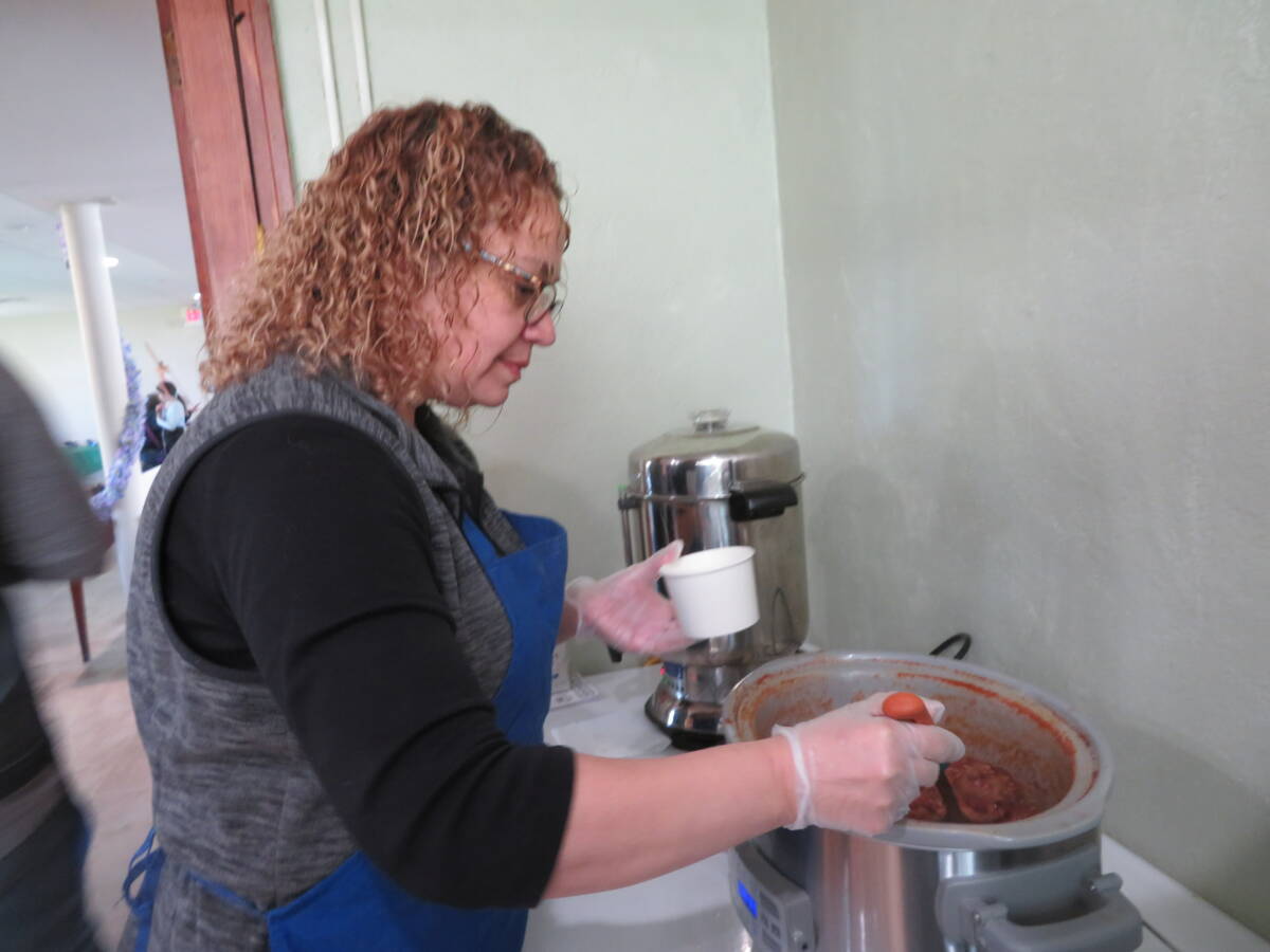 Zulma Soriano prepares a serving of chili.