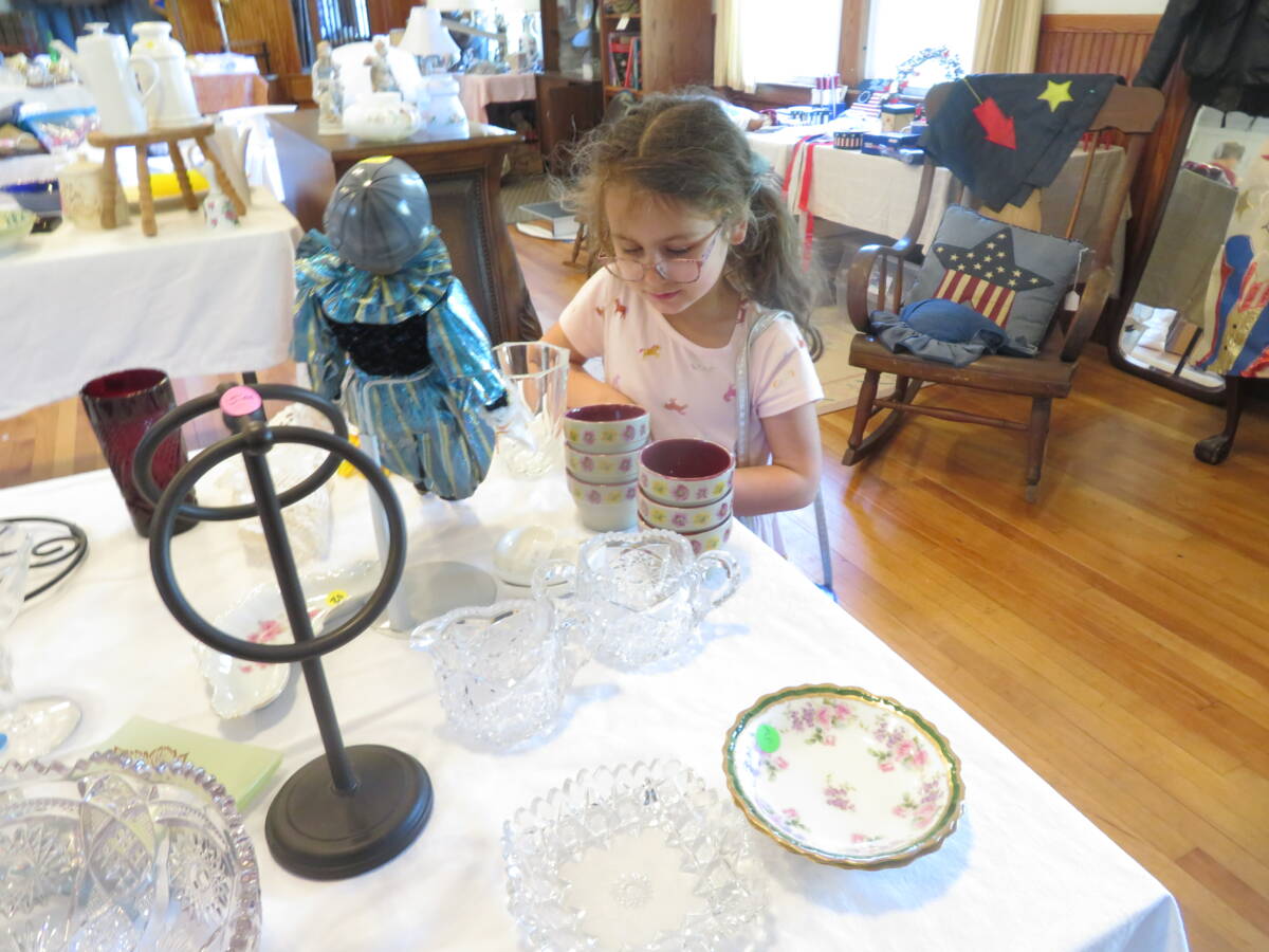 Lucy Gargano, 6, shops at the tag sale.
