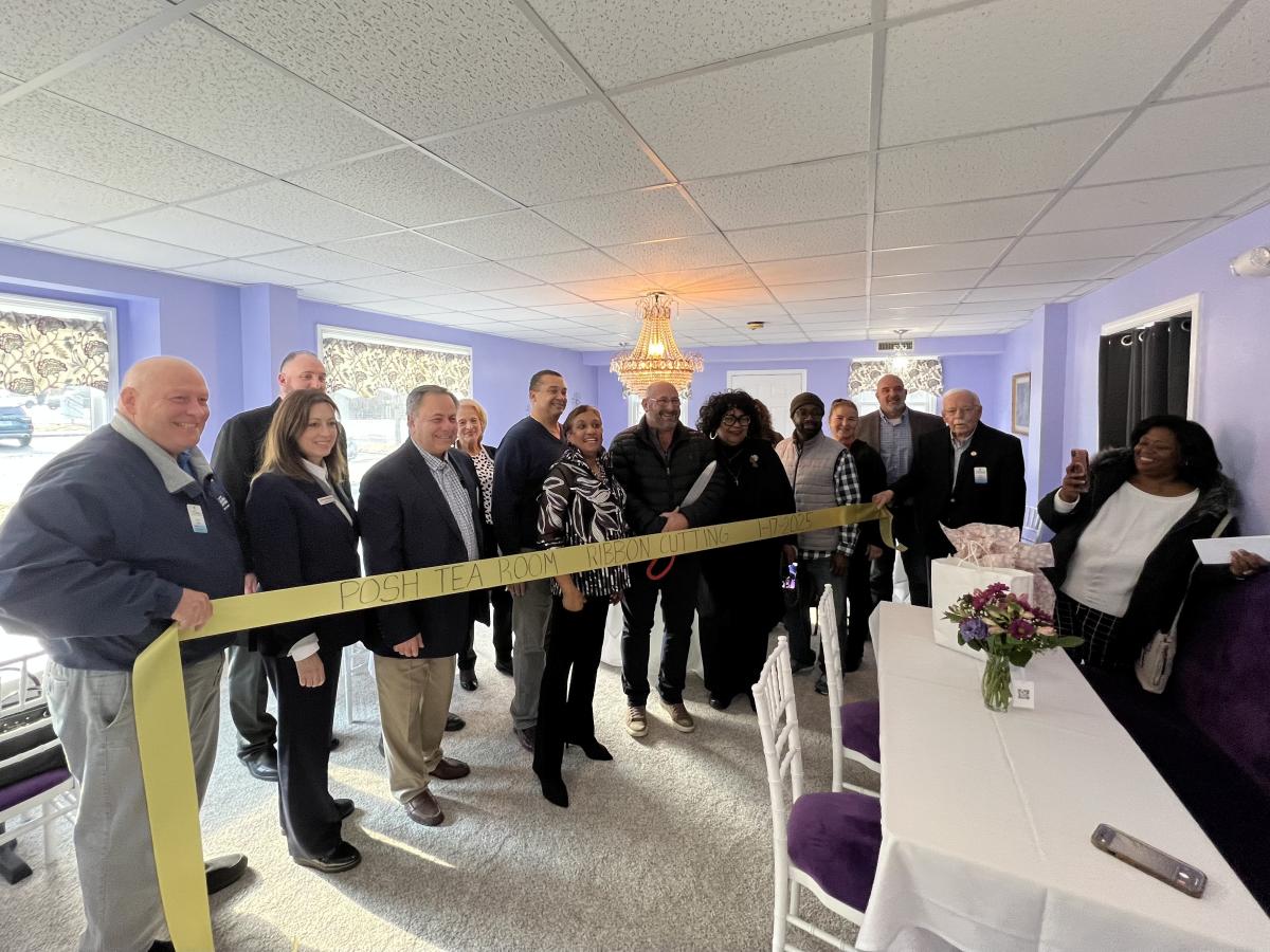 A ribbon cutting ceremony is held for the grand opening celebration of Posh Tea Room.