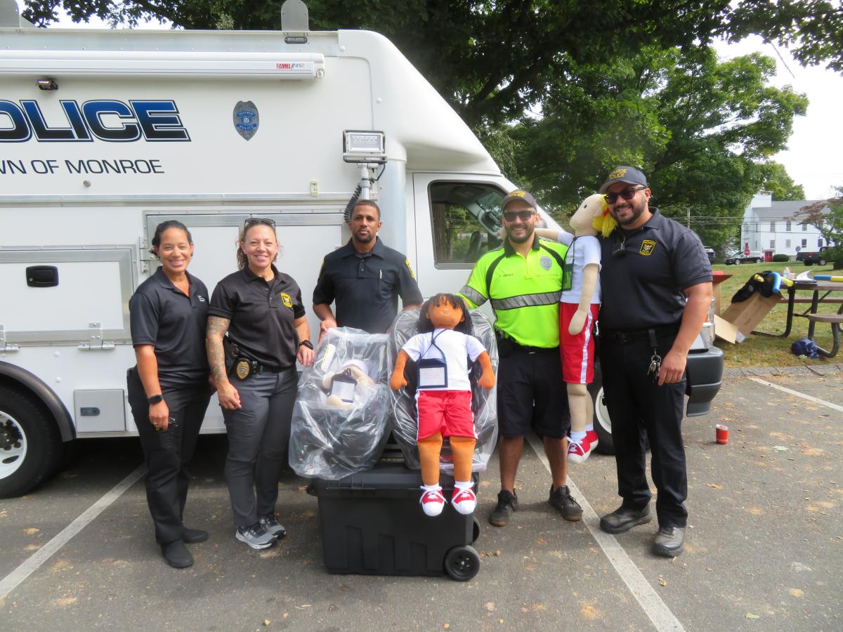 Participating in a free child safety seat clinic is, from left, Rosangela Heredia, an instructor with Yale-New Haven Hospital, Det. Stacy Cascante, Officer Helder Dos Santos, Det. Francisco Jimenez and Officer Omar Wahib.