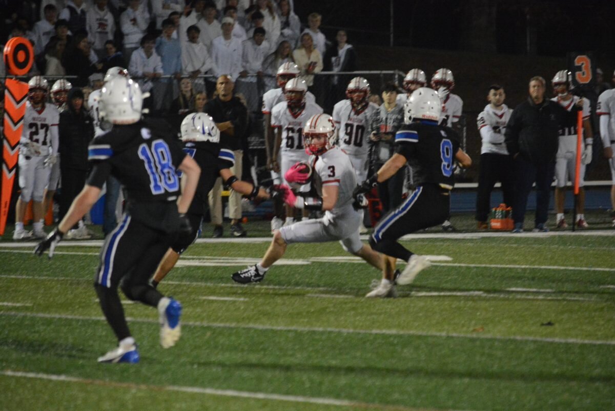 Jake Viglione takes on Newtown defenders.