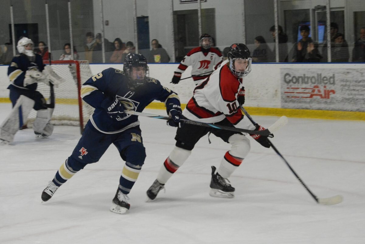 Graham Cybart, right, battles for the puck in the offensive zone.