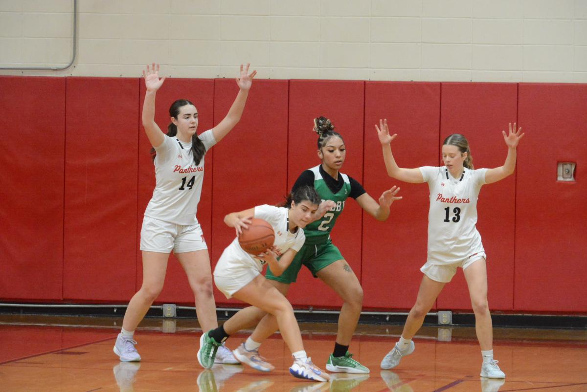 Emma Troesser comes away with a steal as Maddie Farrer (No. 14) and Grace Sheppard (No, 13) stand in position on defense.