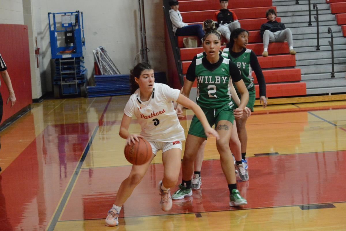 Emma Troesser dribbles under the hoop.