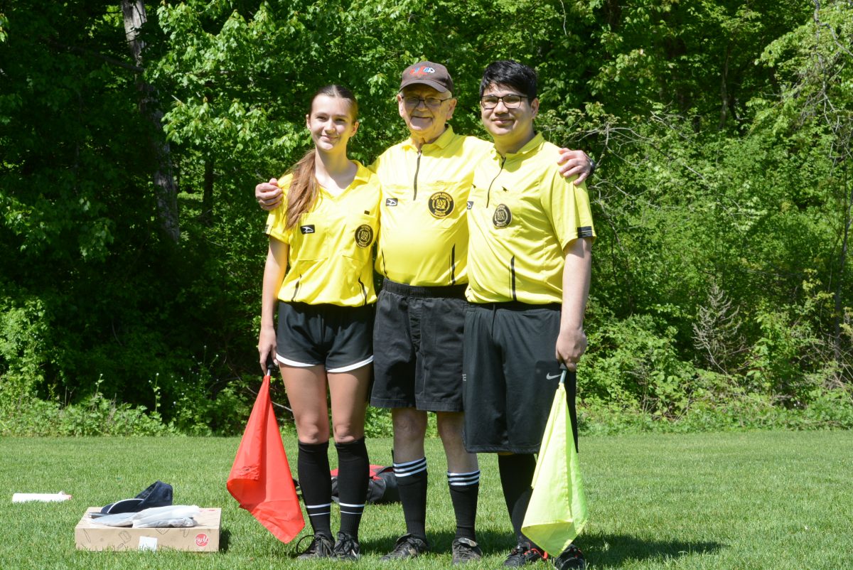 Stan Tait with referees Evelyn Crawford and Yas Raj Verma.