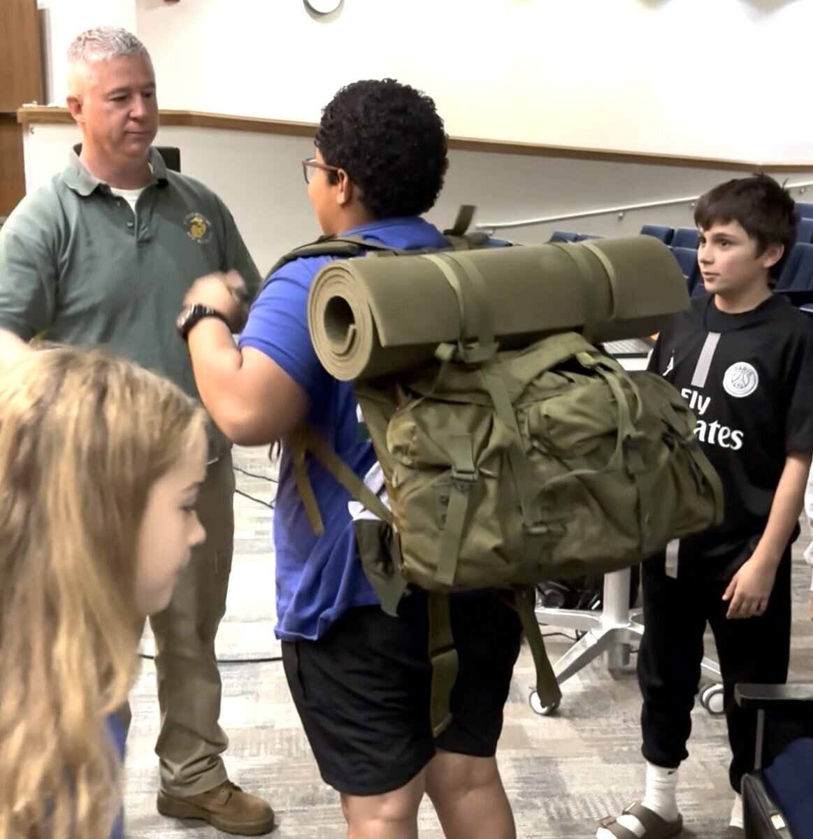 Marine Sgt. Tim Foley let students carry a sleep pack he used during Operation Iraqi Freedom.
