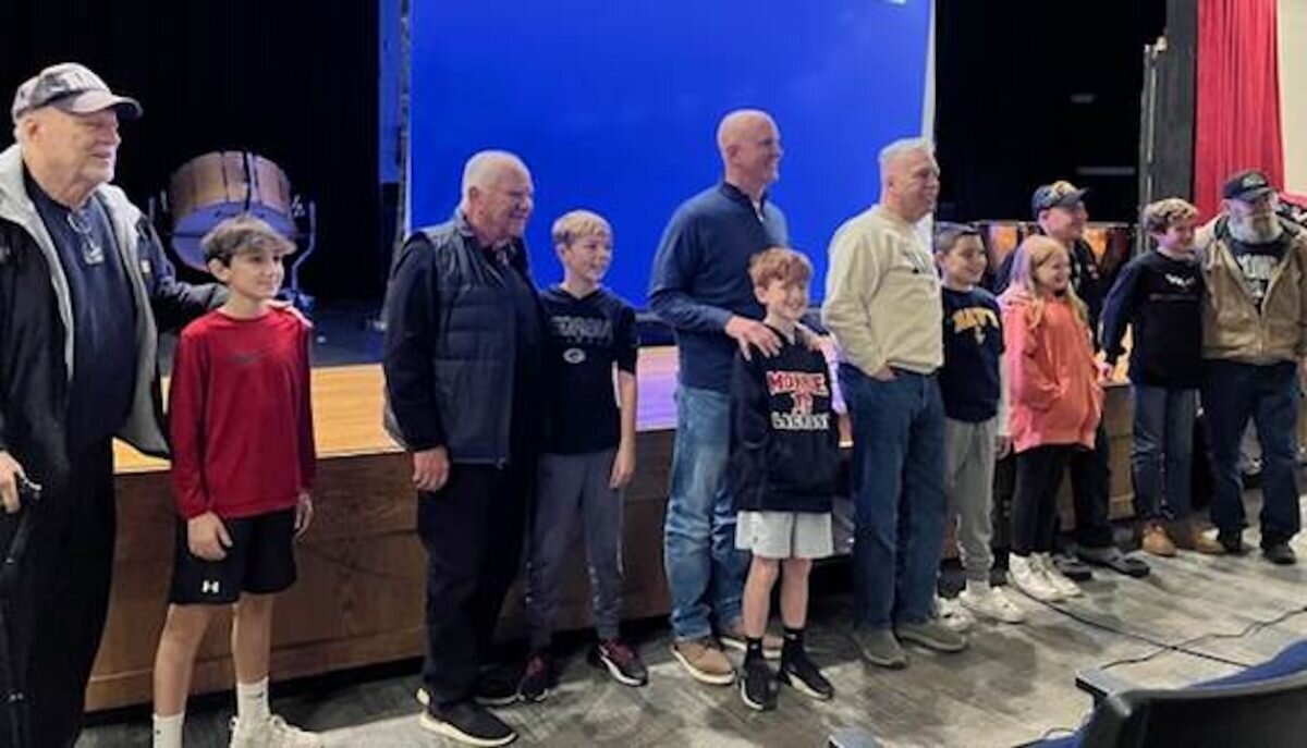 Sixth grade students proudly welcome their family members to the Veterans Day presentation at Jockey Hollow School.