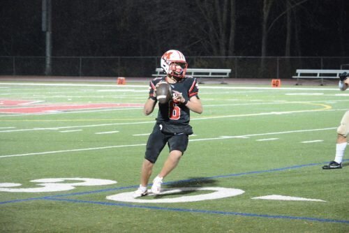 Cole Henderson rolls out to pass.