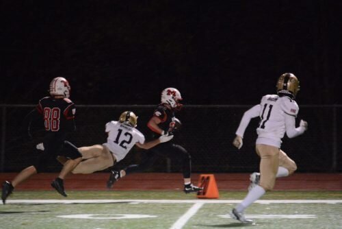 Michael Charland races down the sideline as teammate Ricardo Teixeira joins the play.